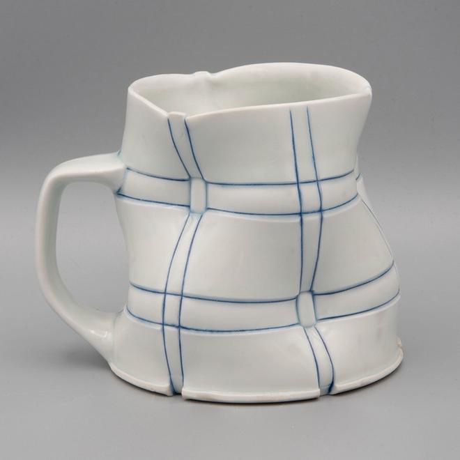 white mug with blue checkered stripes
